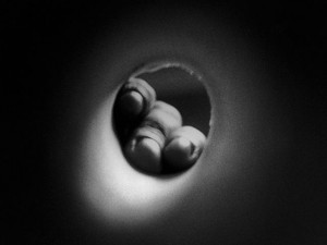 Fingers in a cardboard tube